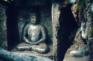 Carved stone Buddha sitting in meditation