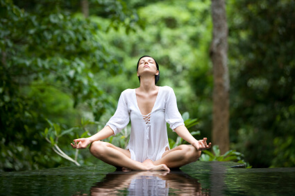 Woman in White Meditating Outside