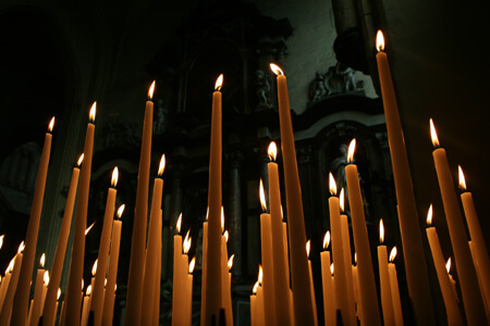 Many Lit Taper Candles in the Night