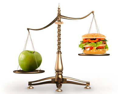 Image of apple and hamburger on scales