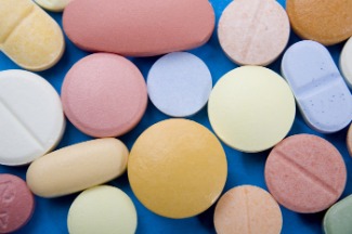 assorted pills of various colors on a blue background