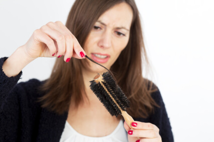 Shocked woman losing hair