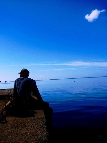 Profile of Person sitting by water